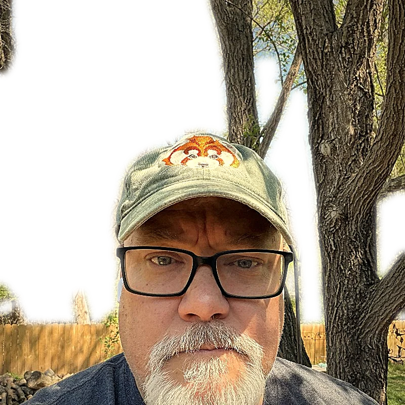 Tom outdoors in a green cap
